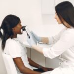 A doctor examining a patient's skin with a dermatoscope