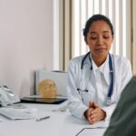 A GP listening to a patient during a consultation in a medical clinic